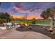 Relaxing backyard with outdoor furniture, desert plants, and views of the golf course at twilight at 28516 N 128Th Dr, Peoria, AZ 85383