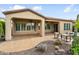 Covered patio with lounge seating, desert landscaping, and smooth concrete at 28516 N 128Th Dr, Peoria, AZ 85383