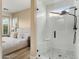 Elegant bathroom featuring a glass-enclosed shower with a built-in bench, white subway tile and mosaic tile flooring at 28516 N 128Th Dr, Peoria, AZ 85383