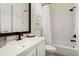 Clean bathroom featuring a white vanity with a square sink, complemented by a bathtub and tiled shower with a curtain at 28516 N 128Th Dr, Peoria, AZ 85383