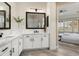 Bright bathroom with double vanity, modern fixtures, and a view into the main bedroom at 28516 N 128Th Dr, Peoria, AZ 85383