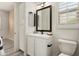 Well-lit bathroom with a framed mirror, white vanity, and shaker-style cabinets providing a clean, modern look at 28516 N 128Th Dr, Peoria, AZ 85383