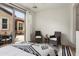 Bright bedroom featuring comfortable chairs, soft rug, and sliding doors to the patio at 28516 N 128Th Dr, Peoria, AZ 85383