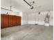 Spacious garage with built-in cabinets and neutral epoxy flooring offers tons of space for storage and vehicles at 28516 N 128Th Dr, Peoria, AZ 85383