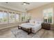 Serene main bedroom with plantation shutters, neutral decor, and a view of the golf course at 28516 N 128Th Dr, Peoria, AZ 85383