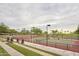 Well-maintained tennis court featuring stadium seating and manicured landscaping at 28516 N 128Th Dr, Peoria, AZ 85383