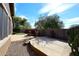 Backyard with stone patio, desert landscaping, dog house, and block wall at 3223 W Rapalo Rd, Phoenix, AZ 85086