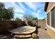 Private backyard with a stone patio, desert landscaping, and block wall at 3223 W Rapalo Rd, Phoenix, AZ 85086