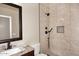 Bathroom featuring a tiled walk-in shower with bronze fixtures and glass surround at 3223 W Rapalo Rd, Phoenix, AZ 85086