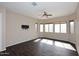 Bedroom with hardwood floors and a tv mount and bright windows at 3223 W Rapalo Rd, Phoenix, AZ 85086