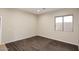 Clean bedroom with hardwood floors and a large window at 3223 W Rapalo Rd, Phoenix, AZ 85086