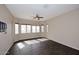 The bedroom features dark wood flooring and lots of natural light from the many windows at 3223 W Rapalo Rd, Phoenix, AZ 85086