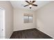 Bedroom with dark wood floors, ceiling fan, and a window at 3223 W Rapalo Rd, Phoenix, AZ 85086