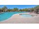 Community pool and hot tub with lounge chairs and shaded seating areas at 3223 W Rapalo Rd, Phoenix, AZ 85086