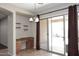 Bright dining area with stylish lighting, workstation, sliding glass doors and outdoor access at 3223 W Rapalo Rd, Phoenix, AZ 85086