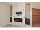 Modern fireplace with a stone surround and custom cabinets at 3223 W Rapalo Rd, Phoenix, AZ 85086