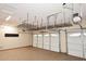 Bright garage with epoxy flooring, storage racks, and two-car garage door at 3223 W Rapalo Rd, Phoenix, AZ 85086