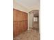 Hallway with tile flooring and ample storage cabinets near the entryway at 3223 W Rapalo Rd, Phoenix, AZ 85086