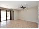 Spacious living room with tile floors and sliding glass doors at 3223 W Rapalo Rd, Phoenix, AZ 85086