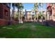 Grassy common area with palm trees, offering a serene outdoor retreat for residents at 330 S Farmer Ave # 121, Tempe, AZ 85281