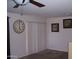 Comfortable living room with a ceiling fan, a decorative clock, and a sliding door with white blinds at 330 S Farmer Ave # 121, Tempe, AZ 85281