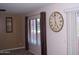 Cozy living room featuring a large clock on the wall and a window with curtains and blinds at 330 S Farmer Ave # 121, Tempe, AZ 85281