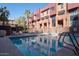 Community swimming pool, complete with lounge chairs and tropical palm trees at 330 S Farmer Ave # 121, Tempe, AZ 85281