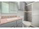 Remodeled bathroom with stone countertop vanity, updated shower and well-appointed lighting at 3402 N 32Nd St # 116, Phoenix, AZ 85018