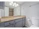 Bathroom featuring granite counters, updated fixtures, and tiled shower, providing a comfortable feel at 3402 N 32Nd St # 116, Phoenix, AZ 85018