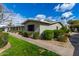 Well-maintained home featuring manicured landscaping, healthy green lawns, and well-lit walkways at 3402 N 32Nd St # 116, Phoenix, AZ 85018