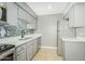 Well lit kitchen with stainless steel appliances, modern cabinets, and mosaic tile backsplash at 3402 N 32Nd St # 116, Phoenix, AZ 85018