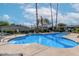 Community swimming pool featuring crystal clear blue water, lush landscaping, and comfortable lounge chairs at 3402 N 32Nd St # 116, Phoenix, AZ 85018