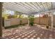 Backyard with brick flooring under a white pergola with lights and greenery around at 4061 N Point Ridge Rd, Buckeye, AZ 85396