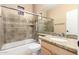 This bathroom features a granite counter, tub, shower, and sliding glass shower doors at 4061 N Point Ridge Rd, Buckeye, AZ 85396