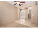 Bedroom with neutral walls, carpet flooring, ceiling fan and a double door entrance at 4061 N Point Ridge Rd, Buckeye, AZ 85396