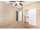 Bedroom with carpeted floor, fan, and double sliding-door closet at 4061 N Point Ridge Rd, Buckeye, AZ 85396