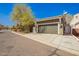 Attached two-car garage with a driveway offers convenient parking, with lovely landscaping in this home's front yard at 4061 N Point Ridge Rd, Buckeye, AZ 85396