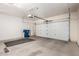 Attached garage with white door, new garage door, and a concrete floor at 4061 N Point Ridge Rd, Buckeye, AZ 85396