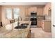 Kitchen island featuring granite countertops, a dual bowl sink, and stainless steel appliances at 4061 N Point Ridge Rd, Buckeye, AZ 85396