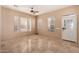 Bright living room with beautiful tiled floors, lots of natural light, and ceiling fan at 4061 N Point Ridge Rd, Buckeye, AZ 85396