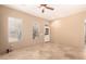 Bright living room with beautiful tiled floors, lots of natural light, and ceiling fan at 4061 N Point Ridge Rd, Buckeye, AZ 85396