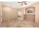 Bright living room with beautiful tiled floors, lots of natural light, and ceiling fan at 4061 N Point Ridge Rd, Buckeye, AZ 85396