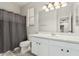 Bathroom featuring a single sink vanity, a tub, a shower, and modern lighting at 4170 N 154Th Dr, Goodyear, AZ 85395