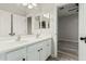 Bright bathroom featuring a dual sink vanity and a connecting door to another bedroom at 4170 N 154Th Dr, Goodyear, AZ 85395