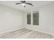 Bright bedroom featuring wood-look flooring, and large windows with views of the outdoors at 4170 N 154Th Dr, Goodyear, AZ 85395