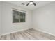 Bright bedroom featuring wood-look flooring, and a large window with views of the outdoors at 4170 N 154Th Dr, Goodyear, AZ 85395