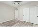 Bedroom with wood flooring, sliding door closet, and neutral color palette at 4170 N 154Th Dr, Goodyear, AZ 85395