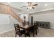 Dining room with wooden table and view into the kitchen and staircase at 4170 N 154Th Dr, Goodyear, AZ 85395