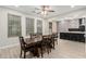 Open dining room featuring a large table and view into the kitchen area at 4170 N 154Th Dr, Goodyear, AZ 85395