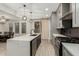 Bright and modern kitchen featuring a center island and gray cabinetry at 4170 N 154Th Dr, Goodyear, AZ 85395